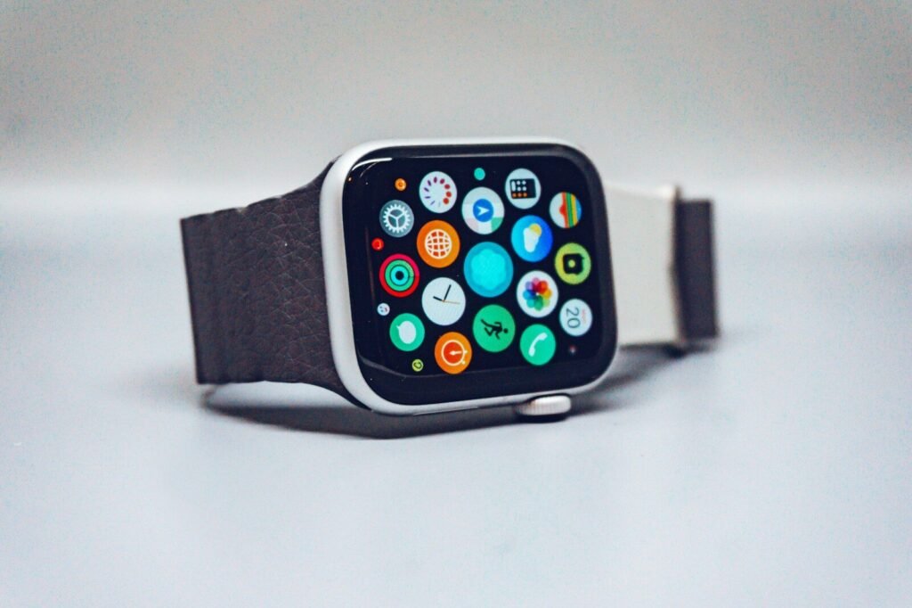 Smartwatch with a dark textured band and colorful app icons on its display, illustrating a smartwatch buying guide