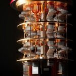 A quantum computer with gold plates and intricate silver wiring against a black background, illustrating quantum computing explained in plain English