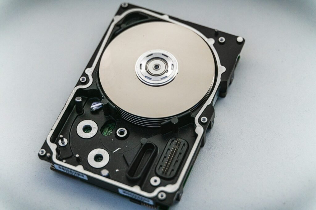 Open hard disk drive showing its internal platters and components, illustrating external drive backups